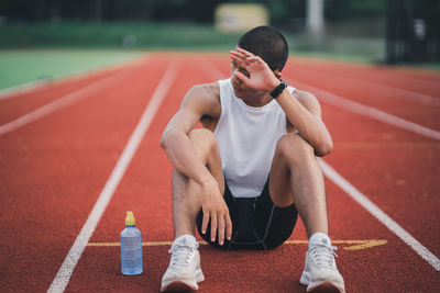 Full length of woman exercising on field