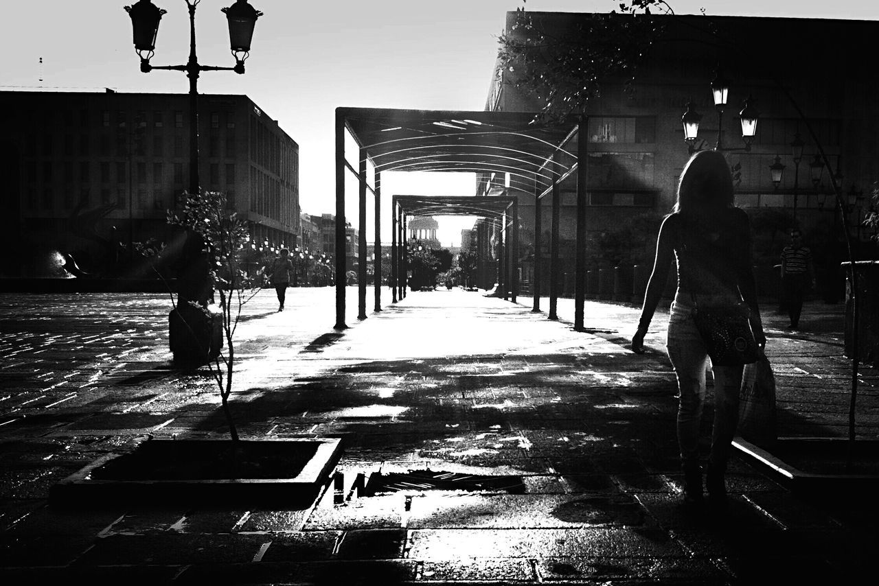WOMAN WALKING ON CITY STREET