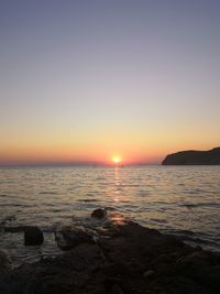 Scenic view of sea against clear sky during sunset