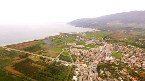 High angle view of buildings on field against sky