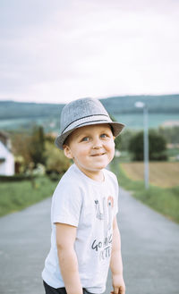 Portrait of boy standing on road