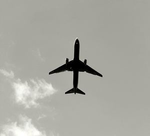 Low angle view of airplane flying in sky