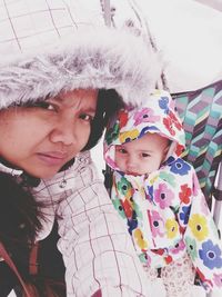 Portrait of mother and daughter outdoors during winter