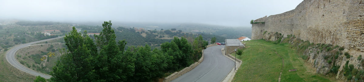 High angle view of vehicles on road amidst trees against sky