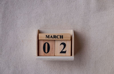 Close-up of information sign on wood