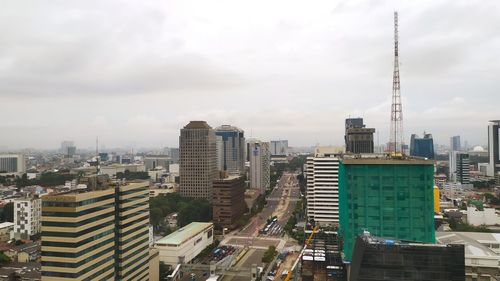 High angle view of modern buildings in city against sky