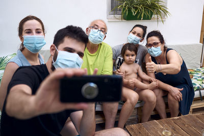A big family making a selfie with surgical masks. concept family