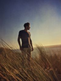 Man standing on field against sky