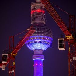 Low angle view of illuminated building against sky