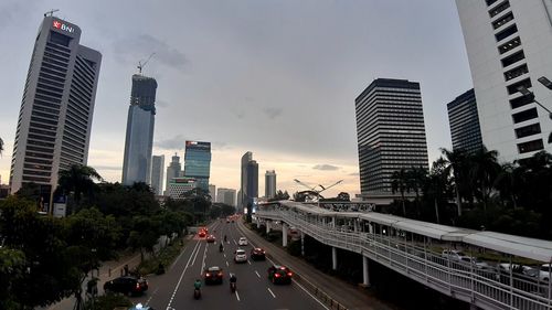 Panoramic view of city street and buildings against sky