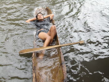 High angle view of woman relaxing in water