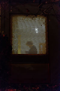Illuminated electric lamp on wall at home