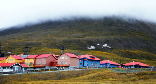 Houses on mountain against sky