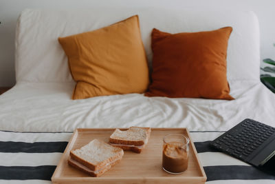 Close-up of breakfast on bed at home