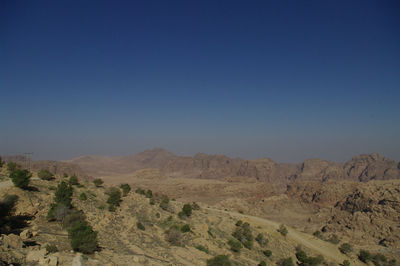 Scenic view of mountains against clear blue sky