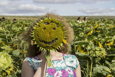 Close-up of woman with sunflower