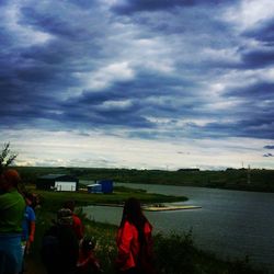 Silhouette of woman against cloudy sky