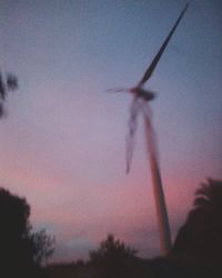 Silhouette of wind turbines at sunset