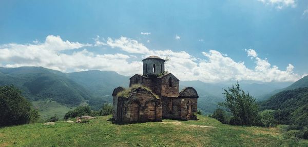 Built structure on landscape against sky