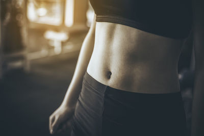 Midsection of teenage girl standing in gym