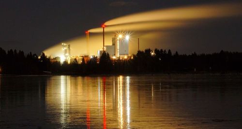 Scenic view of lake against sky at night