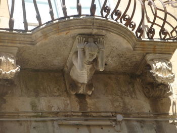 Low angle view of statues against sky