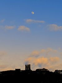 Low angle view of silhouette buildings against sky at sunset