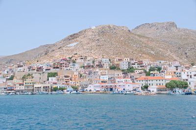 Town by sea against clear sky