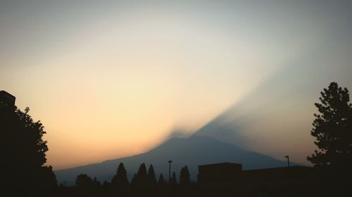 Scenic view of silhouette mountains against sky at sunset