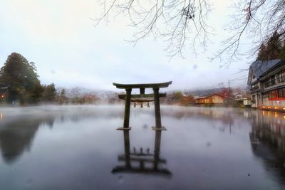 Gazebo in lake against sky