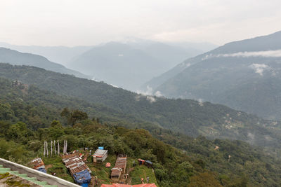 High angle view of building and mountains against sky