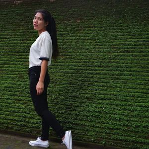 Portrait of woman standing on grass