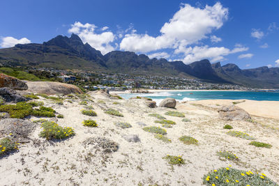 Scenic view of beach and mountains against sky