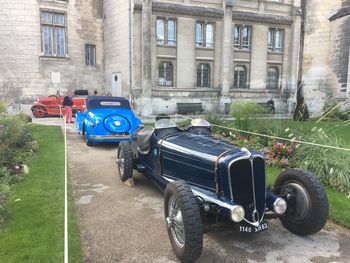 Vintage car parked on street against building