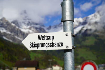 Close-up of road sign against mountain