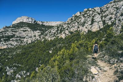 Woman hiking on a mountain path in catalonia on a cloudy summer day