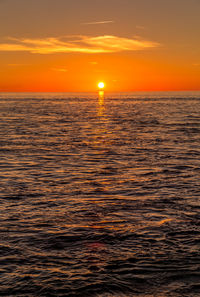 Scenic view of sea against orange sky