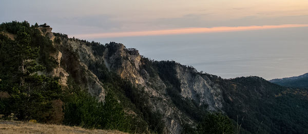 Scenic view of rocky mountains at sunset