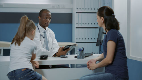 Doctor examining patient in clinic