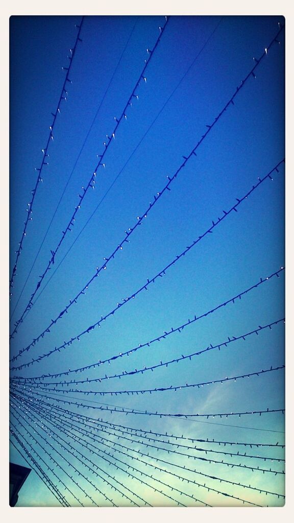 low angle view, power line, cable, connection, electricity, power supply, electricity pylon, transfer print, blue, clear sky, auto post production filter, sky, technology, fuel and power generation, power cable, no people, outdoors, day, backgrounds, complexity