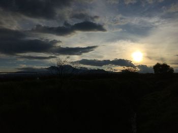 Scenic view of silhouette landscape against sky at sunset