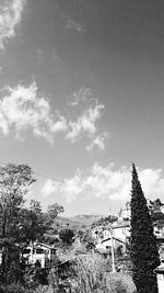 Houses against cloudy sky