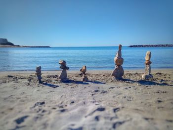 Children on beach against clear sky