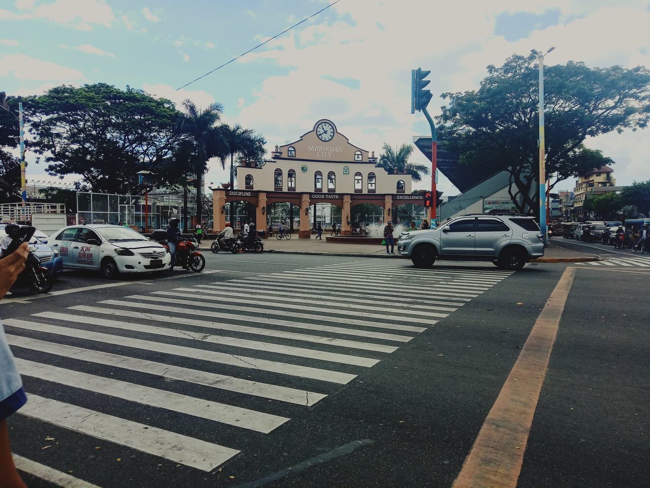 VEHICLES ON ROAD AGAINST BUILDINGS