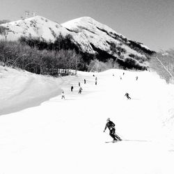 Tourists on snow covered mountain