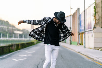 Rear view of man standing on road