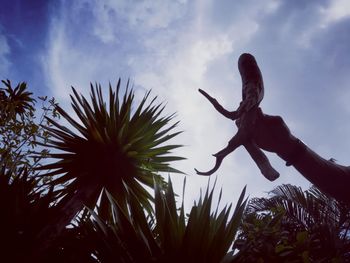 Low angle view of palm tree against sky