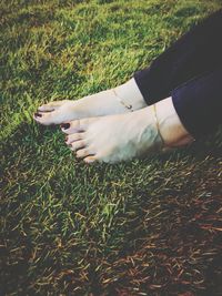 Low section of woman relaxing on field