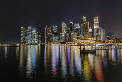 Illuminated city at waterfront