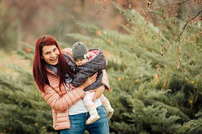 Woman wearing hat against plants